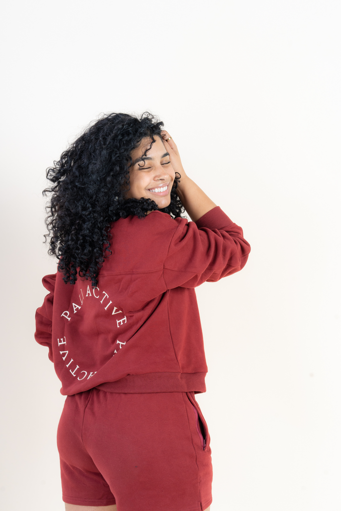 Beautiful model wearing loungewear set with be kind to yourself affirmation in a beautiful burgundy color