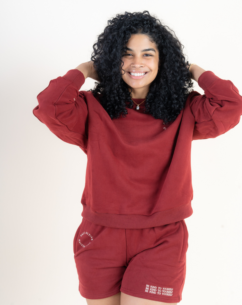 Beautiful model wearing loungewear set with be kind to yourself affirmation in a beautiful burgundy color